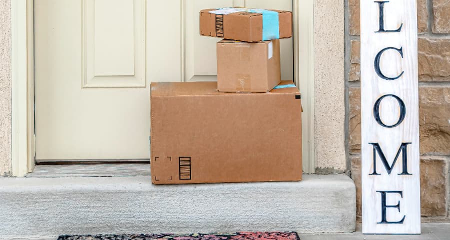 Boxes by the door of a residence with a welcome sign in Worcester